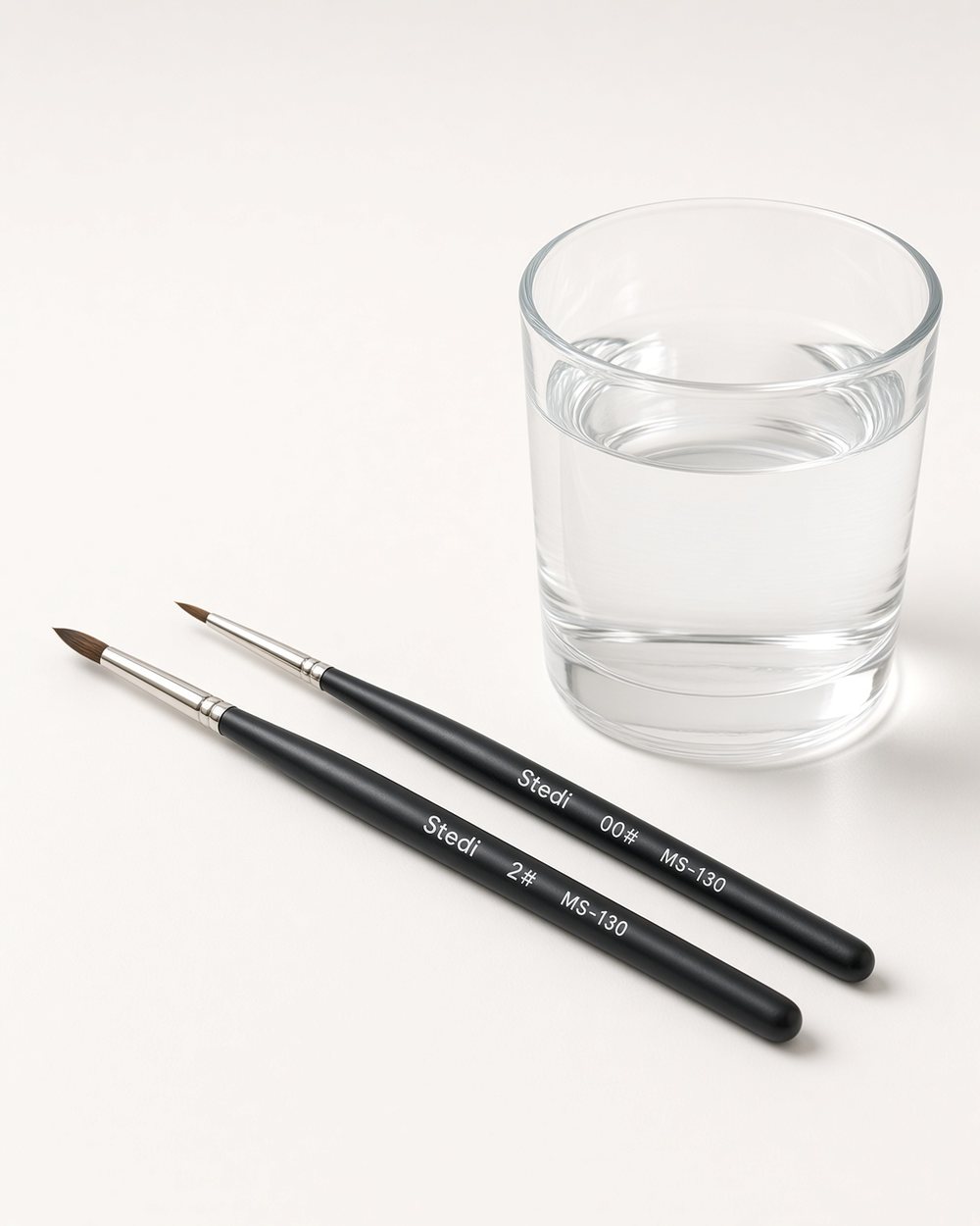Two brushes: a broad one for coats and a fine one for markings