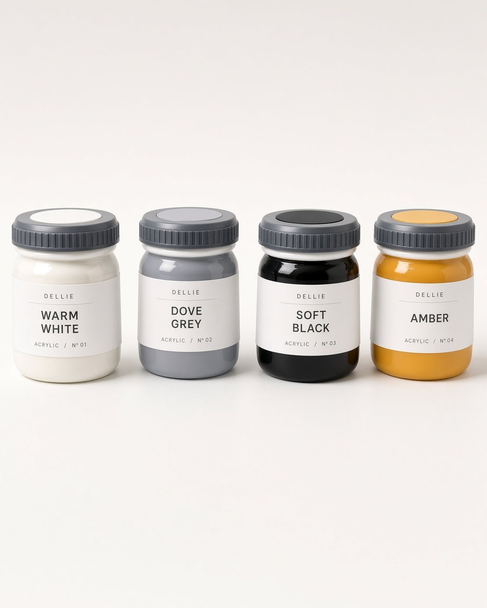 Four pots of Dellie acrylic paint, labelled warm white, dove grey, soft black and amber